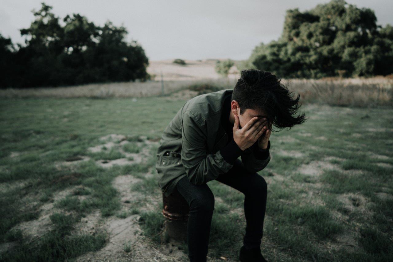 Man holding his head in his hands