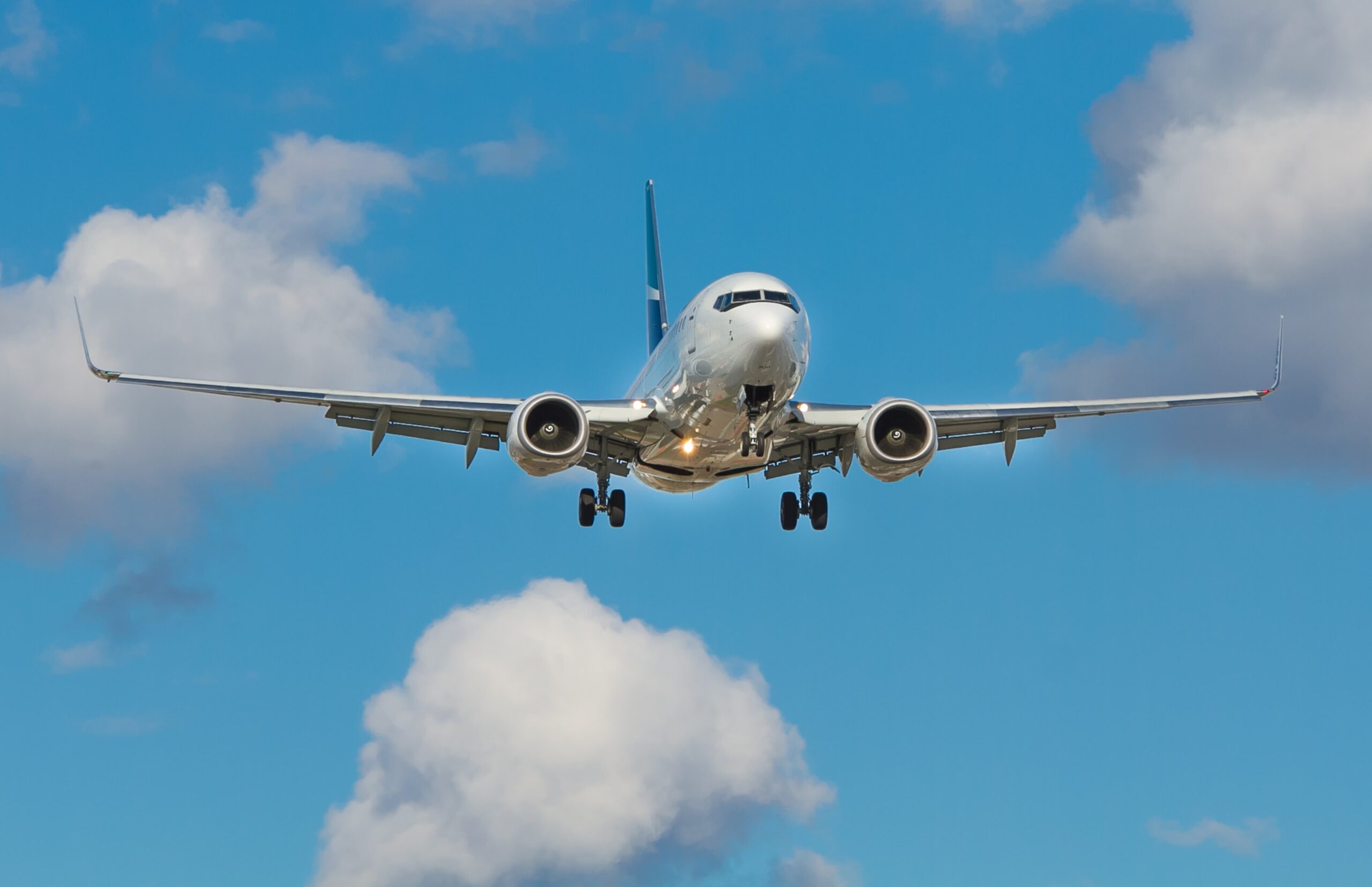 Plane coming in to land with wheels down