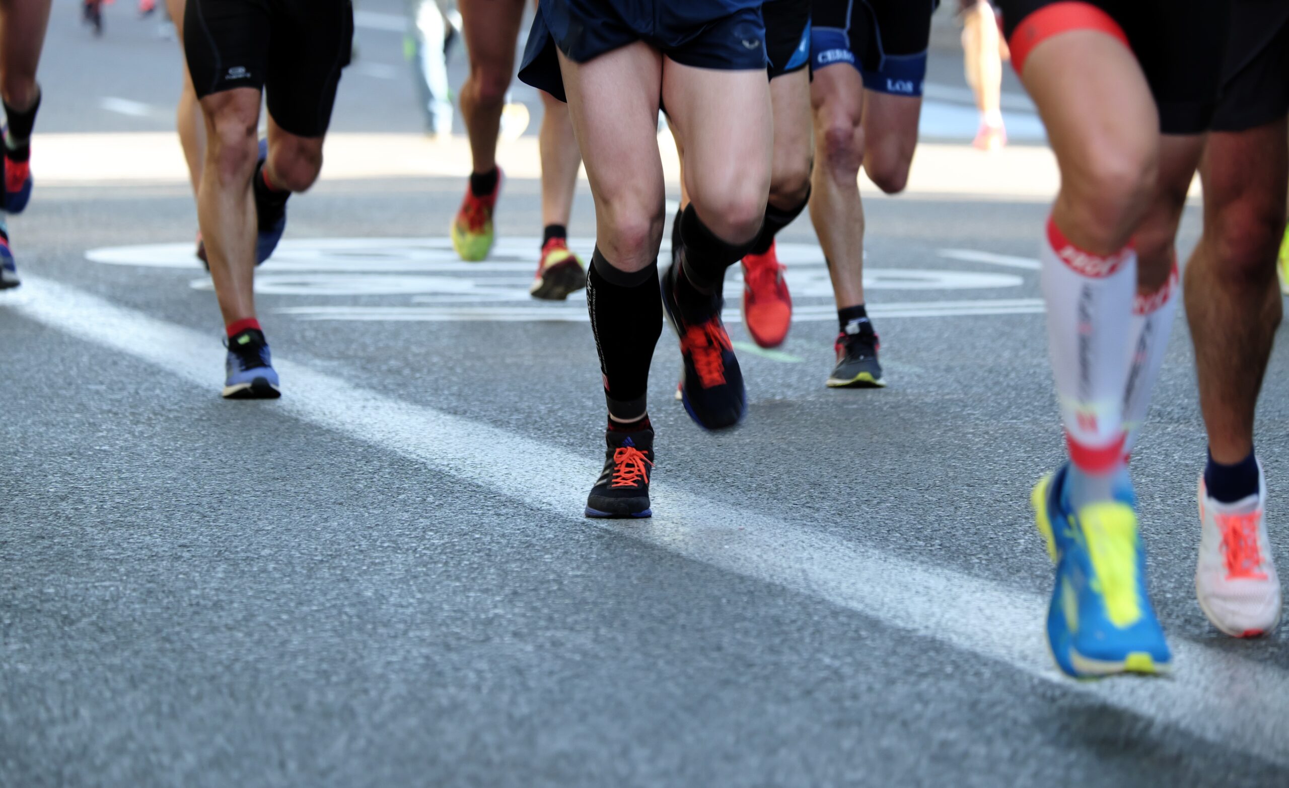 IThe legs of several road runners competing in a race