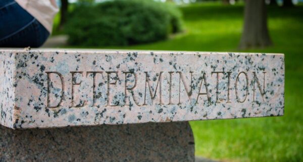 Marble block with the word determination carved into it